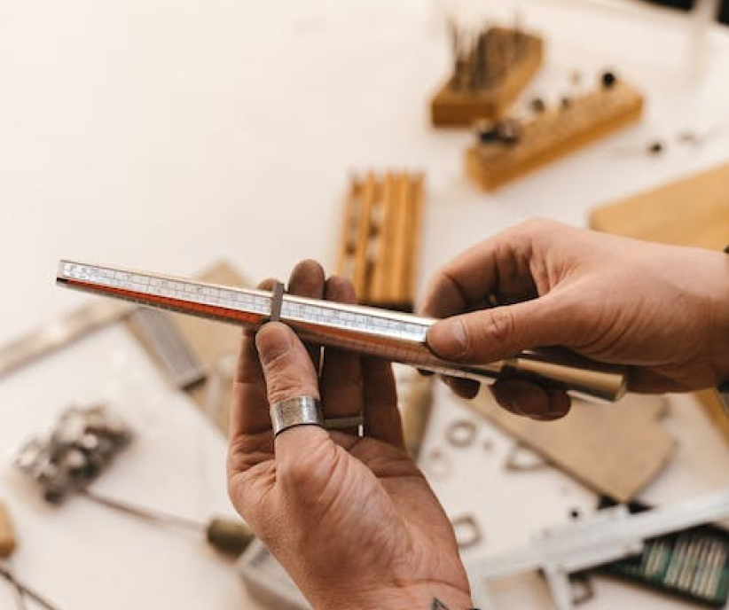 A jeweler filing the shank of a ring by hand